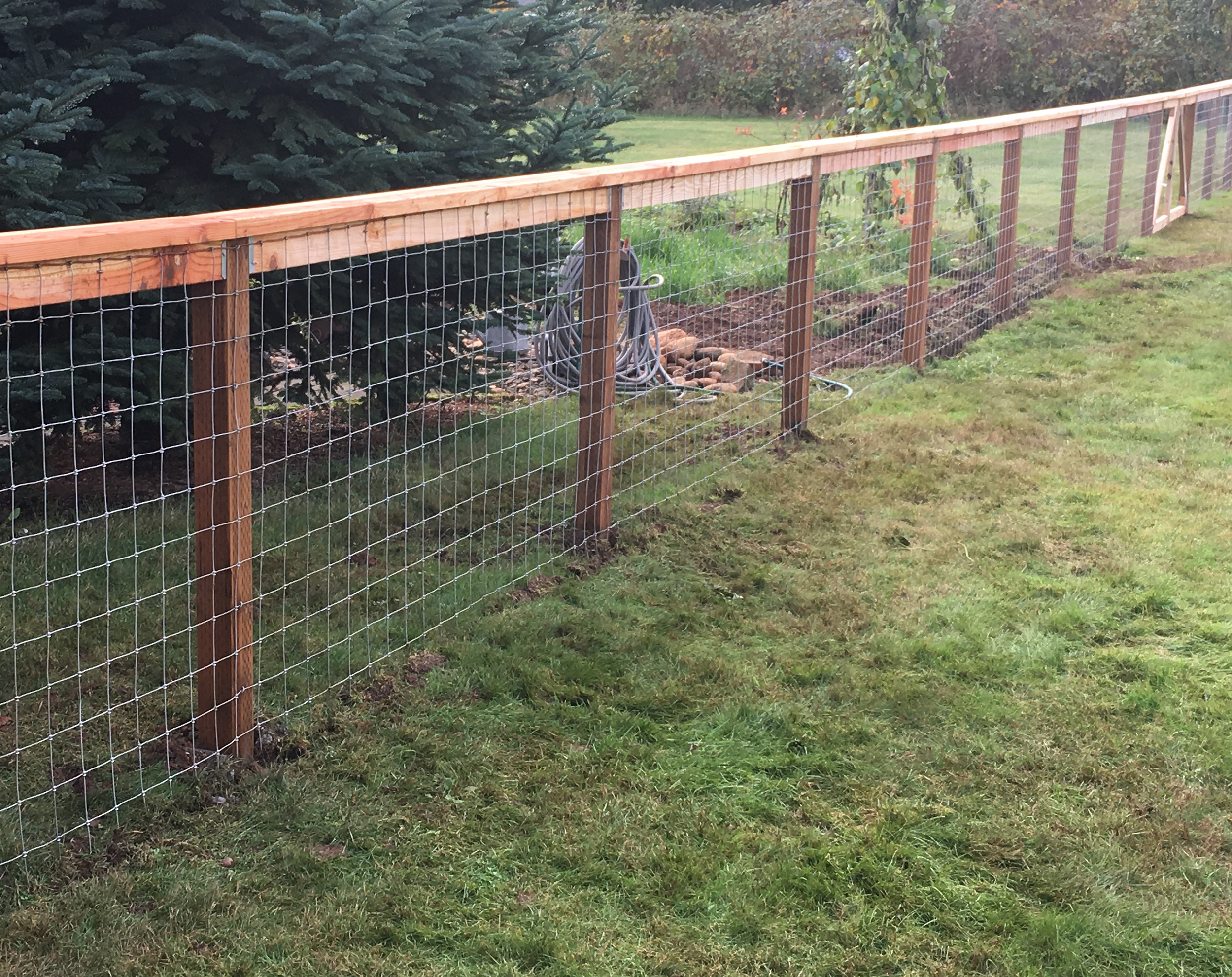 Wire Fence with Cedar Top Rail by The Best Fence Company